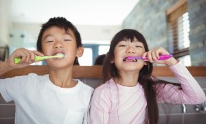 Sibling Children Brushing Teeth