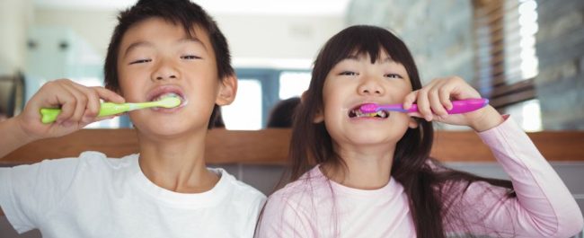 Sibling Children Brushing Teeth